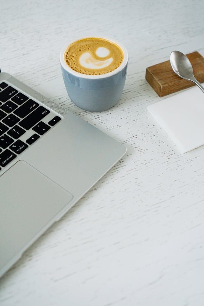 A laptop and coffee mug on a desk
